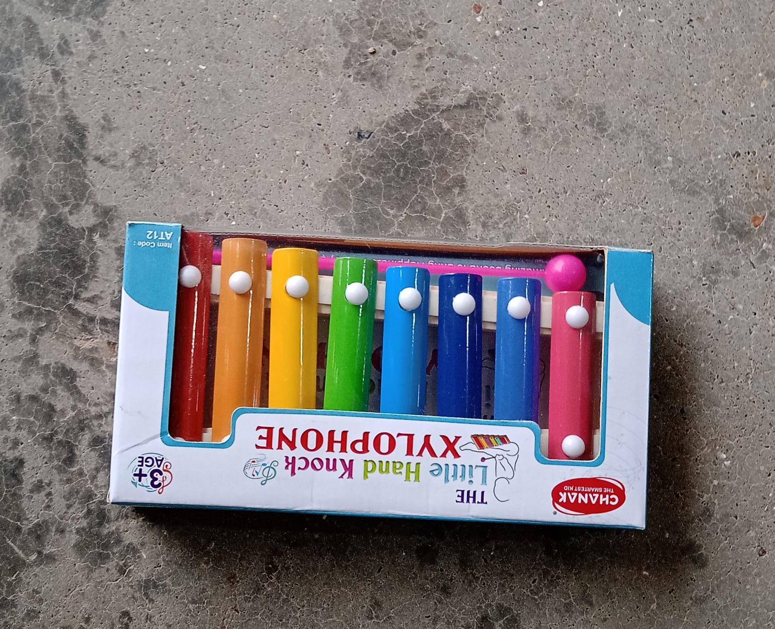 Xylophone with vibrant colored bars and wooden frame, displayed with mallet Xylophone with vibrant colored bars and wooden frame, displayed with mallet